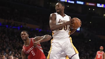 Jan 17, 2016; Los Angeles, CA, USA; Los Angeles Lakers forward Julius Randle (30) grabs a rebound against Houston Rockets forward Terrence Jones (6) during the NBA basketball game at Staples Center. Mandatory Credit: Richard Mackson-USA TODAY Sports