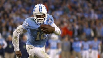 North Carolina Tar Heels quarterback Marquise Williams (12) carries the ball during the second half in the ACC football championship game against the Clemson Tigers at Bank of America Stadium. Mandatory Credit: Joshua S. Kelly-USA TODAY Sports