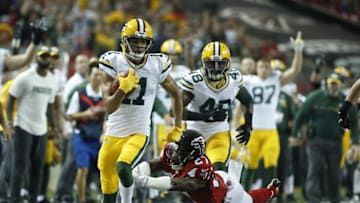 Oct 30, 2016; Atlanta, GA, USA; Green Bay Packers wide receiver Trevor Davis (11) returns a punt as Atlanta Falcons free safety Robenson Therezie (27) attempts to make a tackle in the second quarter of their game at the Georgia Dome. Mandatory Credit: Jason Getz-USA TODAY Sports