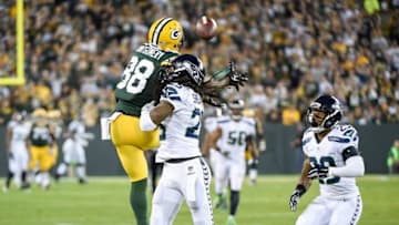 Sep 20, 2015; Green Bay, WI, USA; Seattle Seahawks cornerback Richard Sherman (25) was charged with pass interference on a pass intended for Green Bay Packers wide receiver Ty Montgomery (88) as safety Earl Thomas (29) watches in the second quarter at Lambeau Field. Mandatory Credit: Benny Sieu-USA TODAY Sports
