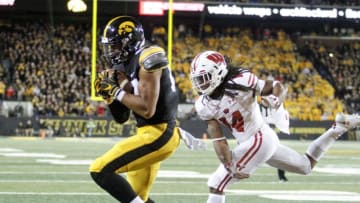 IOWA CITY, IOWA- SEPTEMBER 22: Tight end Noah Fant #87 of the Iowa Hawkeyes catches a touchdown pass during the second half in front of safety D'Cota Dixon #14 of the Wisconsin Badgers on September 22, 2018 at Kinnick Stadium, in Iowa City, Iowa. (Photo by Matthew Holst/Getty Images)