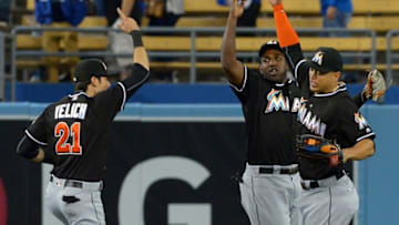 Apr 26, 2016; Los Angeles, CA, USA; Miami Marlins left fielder Christian Yelich (21), center fielder Marcell Ozuna (13) and right fielder Giancarlo Stanton (27) head off the field after defeating the Los Angeles Dodgers 6-3 at Dodger Stadium. Mandatory Credit: Jayne Kamin-Oncea-USA TODAY Sports