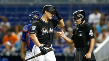 MIAMI, FL - AUGUST 11: J.T. Realmuto #11 of the Miami Marlins reacts after being called out on strikes looking in the first inning against the New York Mets at Marlins Park on August 11, 2018 in Miami, Florida. (Photo by Michael Reaves/Getty Images)