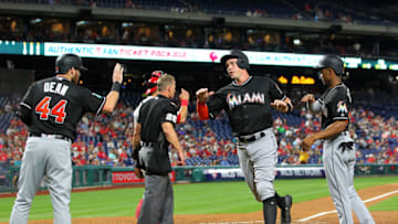 PHILADELPHIA, PA - SEPTEMBER 15: Peter O'Brien #45 of the Miami Marlins is congratulated by Austin Dean #44 and Magneuris Sierra #34 after all three score on a double by JT Riddle #10 during the second inning against the Philadelphia Phillies during a game at Citizens Bank Park on September 15, 2018 in Philadelphia, Pennsylvania. The Phillies defeated the Marlins 5-4.(Photo by Rich Schultz/Getty Images)