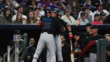 ATLANTA, GEORGIA - APRIL 06: Peter O'Brien #45 of the Miami Marlins hugs his teammate Martin Prado #14 against the Atlanta Braves at SunTrust on April 06, 2019 in Atlanta, Georgia. (Photo by Logan Riely/Getty Images)