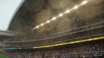 MIAMI, FL - APRIL 06: Teams retreat to the dugout during a rain delay at Marlins Park during Opening Day between the Miami Marlins and the Atlanta Braves on April 6, 2015 in Miami, Florida. (Photo by Mike Ehrmann/Getty Images)