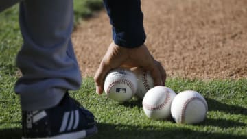 ANAHEIM, CA - JULY 17: Baseballs are picked up on the infeild during batting practice between the Los Angeles Angels of Anaheim and Houston Astros at Angel Stadium of Anaheim on July 17, 2019 in Anaheim, California. Astros won 12-2. (Photo by John McCoy/Getty Images)
