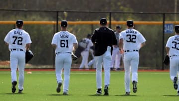 (From left) Tigers pitchers Garrett Hill, Logan Shore, director of pitching Gabe Ribas, Ty Madden and Jackson Jobe run to the next drill at the spring training minor league minicamp Thursday, Feb.17, 2022 at Tiger Town in Lakeland, Florida.