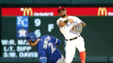 Oct 12, 2015; Arlington, TX, USA; Texas Rangers second baseman Rougned Odor (12) turns a double play overToronto Blue Jays shortstop Troy Tulowitzki (2) during the ninth inning in game four of the ALDS at Globe Life Park in Arlington. Mandatory Credit: Tim Heitman-USA TODAY Sports