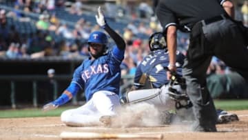 Mar 21, 2015; Surprise, AZ, USA; Texas Rangers right fielder Nomar Mazara (43) beats the tag of Milwaukee Brewers catcher Martin Maldonado (12) to score a run at Surprise Stadium. Mandatory Credit: Joe Camporeale-USA TODAY Sports