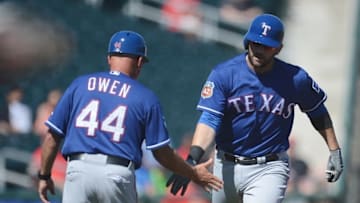 Mar 9, 2016; Goodyear, AZ, USA; Texas Rangers first baseman Mitch Moreland (18) slaps hands with Texas Rangers third base coach Spike Owen (44) after hitting a home run against the Cincinnati Reds during the third inning at Goodyear Ballpark. Mandatory Credit: Joe Camporeale-USA TODAY Sports