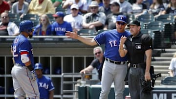 Apr 24, 2016; Chicago, IL, USA; Texas Rangers manager Jeff Banister (center) talks to MLB umpire David Rackley (right) during the first inning of a MLB game against the Chicago White Sox at U.S. Cellular Field. Mandatory Credit: Kamil Krzaczynski-USA TODAY Sports