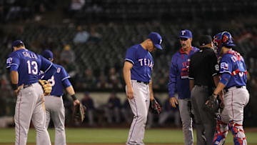 Jun 10, 2015; Oakland, CA, USA; Texas Rangers pitching coach Mike Maddux (31) comes out to the mound to talk with his pitcher Keone Kela (50) and catcher Robinson Chirinos (61) in the ninth inning against the Oakland Athletics at O.co Coliseum. Mandatory Credit: Lance Iversen-USA TODAY Sports.