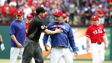 May 15, 2016; Arlington, TX, USA; Third Base umpire Lance Barrett (94) restrains Texas Rangers manager Jeff Banister (28) in the eighth inning at Globe Life Park in Arlington. Mandatory Credit: Tim Heitman-USA TODAY Sports