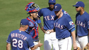 Sep 18, 2016; Arlington, TX, USA; Texas Rangers starting pitcher Colby Lewis (48) hands the ball over to manager Jeff Banister (28) during the sixth inning of a baseball game against the Oakland Athletics at Globe Life Park in Arlington. Mandatory Credit: Jim Cowsert-USA TODAY Sports