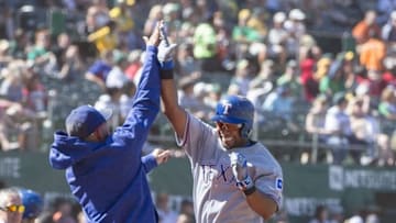 Sep 24, 2016; Oakland, CA, USA; Texas Rangers shortstop Elvis Andrus (1) gets a high five by teammate after hitting a two run home run during the sixth inning against the Oakland Athletics at Oakland Coliseum the Texas Rangers defeated the Oakland Athletics 5 to 0. Mandatory Credit: Neville E. Guard-USA TODAY Sports