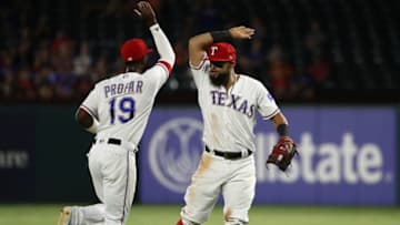 ARLINGTON, TX - AUGUST 16: (L-R) Jurickson Profar #19 and Rougned Odor #12 of the Texas Rangers celebrate a triple play against the Los Angeles Angels in the fourth inning at Globe Life Park in Arlington on August 16, 2018 in Arlington, Texas. (Photo by Ronald Martinez/Getty Images)