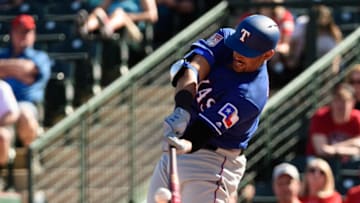 TEMPE, ARIZONA - FEBRUARY 28: Ronald Guzman #11 of the Texas Rangers hits a solo home run in the spring training game against the Los Angeles Angels at Tempe Diablo Stadium on February 28, 2019 in Tempe, Arizona. (Photo by Jennifer Stewart/Getty Images)
