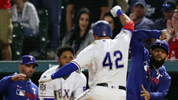 ARLINGTON, TEXAS - APRIL 15: Elvis Andrus #1 and Rougned Odor #12 of the Texas Rangers greet Asdrubal Cabrera #14 of the Texas Rangers after his two-run home run against the Los Angeles Angels in the sixth inning at Globe Life Park in Arlington on April 15, 2019 in Arlington, Texas. All players are wearing the number 42 in honor of Jackie Robinson Day. (Photo by Richard Rodriguez/Getty Images)