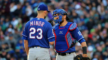 SEATTLE, WASHINGTON - APRIL 27: Mike Minor #23 and Jeff Mathis #2 of the Texas Rangers have a conversation on the mound in the fourth inning against the Seattle Mariners during their game at T-Mobile Park on April 27, 2019 in Seattle, Washington. (Photo by Abbie Parr/Getty Images)