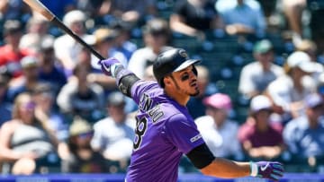 DENVER, CO - AUGUST 18: Nolan Arenado #28 of the Colorado Rockies follows the flight of a first inning solo home run against the Miami Marlins at Coors Field on August 18, 2019 in Denver, Colorado. (Photo by Dustin Bradford/Getty Images)
