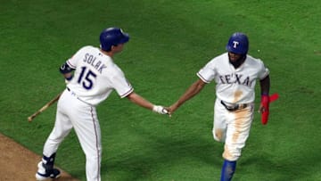 ARLINGTON, TEXAS - SEPTEMBER 12: Nick Solak #15 of the Texas Rangers greets Delino DeShields #3 who scored on a wild pitch by Peter Fairbanks of the Tampa Bay Rays at Globe Life Park in Arlington on September 12, 2019 in Arlington, Texas. (Photo by Richard Rodriguez/Getty Images)