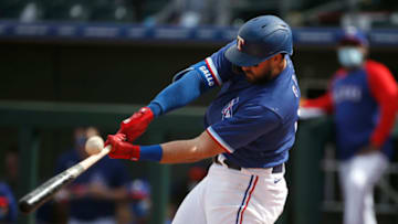 SURPRISE, ARIZONA - MARCH 07: Joey Gallo #13 of the Texas Rangers fouls off a pitch against the Los Angeles Dodgers during the fifth inning of the MLB spring training baseball game at Surprise Stadium on March 07, 2021 in Surprise, Arizona. (Photo by Ralph Freso/Getty Images)