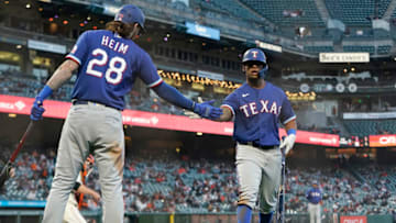 SAN FRANCISCO, CALIFORNIA - MAY 10: Khris Davis #4 of the Texas Rangers is congratulated by Jonah Heim #28 after Davis scored against the San Francisco Giants in the fifth inning at Oracle Park on May 10, 2021 in San Francisco, California. (Photo by Thearon W. Henderson/Getty Images)