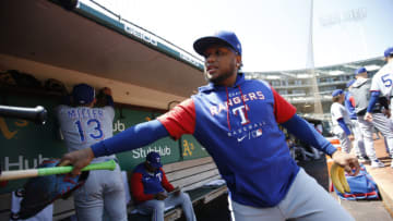 OAKLAND, CA - APRIL 24: Willie Calhoun #4 of the Texas Rangers in the dugout before the game against the Oakland Athletics at RingCentral Coliseum on April 24, 2022 in Oakland, California. The Athletics defeated the Rangers 2-0. (Photo by Michael Zagaris/Oakland Athletics/Getty Images)