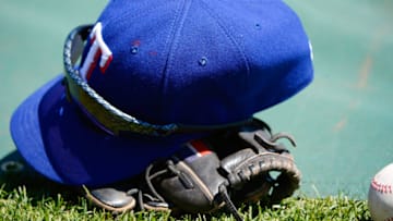 SAN FRANCISCO, CA - JUNE 09: A glove, hat, sunglasses, and a baseball belonging ot a Texas Ranger lays on the field during batting practice before their game against the San Francisco Giants at AT&T Park on June 9, 2012 in San Francisco, California. The Giants won the game 5-2. (Photo by Thearon W. Henderson/Getty Images)
