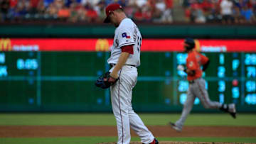 ARLINGTON, TX - JULY 29: Austin Bibens-Dirkx #56 of the Texas Rangers reacts after giving up a solo home run to Caleb Joseph #36 of the Baltimore Orioles during the second inning at Globe Life Park in Arlington on July 29, 2017 in Arlington, Texas. The Orioles won 4-0. (Photo by Ron Jenkins/Getty Images)
