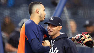 NEW YORK, NY - OCTOBER 16: Carlos Correa #1 of the Houston Astros hugs Joe Espada #53 of the New York Yankees before Game Three of the American League Championship Series at Yankee Stadium on October 16, 2017 in the Bronx borough of New York City. (Photo by Elsa/Getty Images)