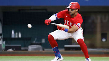 ARLINGTON, TX - OCTOBER 1: Leody Taveras #3 of the Texas Rangers bunts against the Cleveland Indians during the second inning at Globe Life Field on October 1, 2021 in Arlington, Texas. (Photo by Ron Jenkins/Getty Images)
