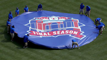 ARLINGTON, TEXAS - MARCH 28: Grounds crew members remove a tarp off the pitchers mound prior to the Texas Rangers taking on the Chicago Cubs during Opening Day at Globe Life Park in Arlington on March 28, 2019 in Arlington, Texas. (Photo by Tom Pennington/Getty Images)
