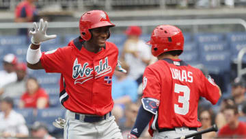 WASHINGTON, DC - JULY 15: Seuly Matias #25 of the Kansas City Royals and the World Team celebrates with teammate Leody Taveras #3 of the Texas Rangers and the World Team after after hitting a solo home run against the U.S. Team in the second inning during the SiriusXM All-Star Futures Game at Nationals Park on July 15, 2018 in Washington, DC. (Photo by Rob Carr/Getty Images)