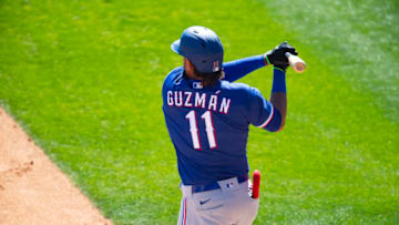 Mar 2, 2021; Phoenix, Arizona, USA; Texas Rangers infielder Ronald Guzman hits a home run against the Chicago White Sox during a Spring Training game at Camelback Ranch Glendale. Mandatory Credit: Mark J. Rebilas-USA TODAY Sports