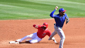 Mar 3, 2021; Tempe, Arizona, USA; Texas Rangers second baseman Andy Ibanez (77) turns a double play on Los Angeles Angels left fielder Justin Upton (10) during the second inning during a spring training game at Tempe Diablo Stadium. Mandatory Credit: Matt Kartozian-USA TODAY Sports