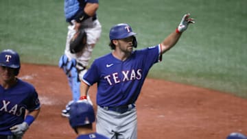 Apr 13, 2021; St. Petersburg, Florida, USA; Texas Rangers shortstop Charlie Culberson (C) celebrates after hitting a two-run home run during the eighth inning against the Tampa Bay Rays at Tropicana Field. Mandatory Credit: Kim Klement-USA TODAY Sports
