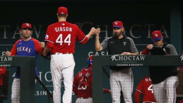 Jun 4, 2021; Arlington, Texas, USA; Texas Rangers starting pitcher Kyle Gibson (44) fist pumps manager Chris Woodward (8) as he heads to the dugout after pitching the top of the fourth inning against the Tampa Bay Rays at Globe Life Field. Mandatory Credit: Raymond Carlin III-USA TODAY Sports