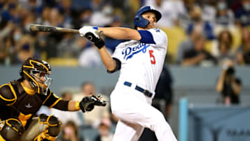 Sep 30, 2021; Los Angeles, California, USA; Los Angeles Dodgers shortstop Corey Seager (5) hits a solo home run in the first inning of the game against the San Diego Padres at Dodger Stadium. Mandatory Credit: Jayne Kamin-Oncea-USA TODAY Sports