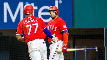 Oct 1, 2021; Arlington, Texas, USA; Texas Rangers third baseman Andy Ibanez (77) celebrates with catcher Jose Trevino (23) after scoring during the second inning against the Cleveland Indians at Globe Life Field. Mandatory Credit: Kevin Jairaj-USA TODAY Sports