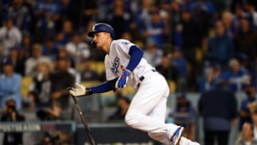 Oct 21, 2021; Los Angeles, California, USA; Los Angeles Dodgers shortstop Corey Seager (5) hits a single in the eighth inning against the Atlanta Braves during game five of the 2021 NLCS at Dodger Stadium. Mandatory Credit: Jayne Kamin-Oncea-USA TODAY Sports