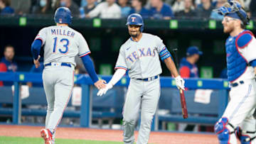 Apr 8, 2022; Toronto, Ontario, CAN; Texas Rangers left fielder Brad Miller (13) celebrates hitting a home run with second baseman Marcus Semien (2) during the first inning against the Toronto Blue Jays at Rogers Centre . Mandatory Credit: Nick Turchiaro-USA TODAY Sports