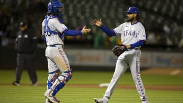 May 27, 2022; Oakland, California, USA; Texas Rangers catcher Jonah Heim (28) and pitcher Dennis Santana (19) celebrate their 8-5 victory over the Oakland Athletics at RingCentral Coliseum. Mandatory Credit: D. Ross Cameron-USA TODAY Sports