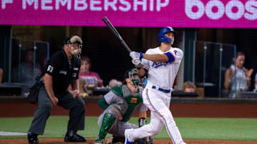 Jul 11, 2022; Arlington, Texas, USA; Texas Rangers shortstop Corey Seager (5) hits a home run against the Oakland Athletics during the fifth inning at Globe Life Field. Mandatory Credit: Jerome Miron-USA TODAY Sports