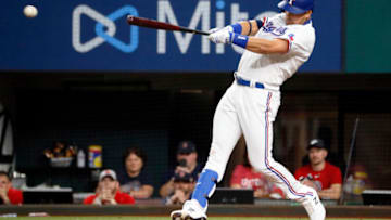 May 1, 2021; Arlington, Texas, USA; Texas Rangers first baseman Nate Lowe (30) hits a two-run single during the third inning against the Boston Red Sox at Globe Life Field. Mandatory Credit: Raymond Carlin III-USA TODAY Sports
