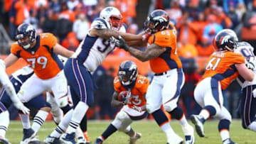 Jan 24, 2016; Denver, CO, USA; Denver Broncos running back Ronnie Hillman (23) runs the ball as offensive tackle Louis Vasquez (65) blocks New England Patriots defensive lineman Alan Branch (97) in the AFC Championship football game at Sports Authority Field at Mile High. The Broncos defeated the Patriots 20-18 to advance to the Super Bowl. Mandatory Credit: Mark J. Rebilas-USA TODAY Sports