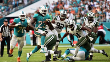 Nov 6, 2016; Miami Gardens, FL, USA; Miami Dolphins running back Jay Ajayi (23) runs past New York Jets linebacker Julian Stanford (51) during the second half at Hard Rock Stadium. The Dolphins won 27-23. Mandatory Credit: Steve Mitchell-USA TODAY Sports
