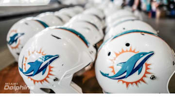 Dolphins helmets sit on a table at the teams annual "garage" sale - image courtesy of MiamiDolphins.com