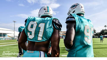 DE's Cameron Wake and William Hayes talk at training camp proactice - image courtesy of MiamiDolphins.com